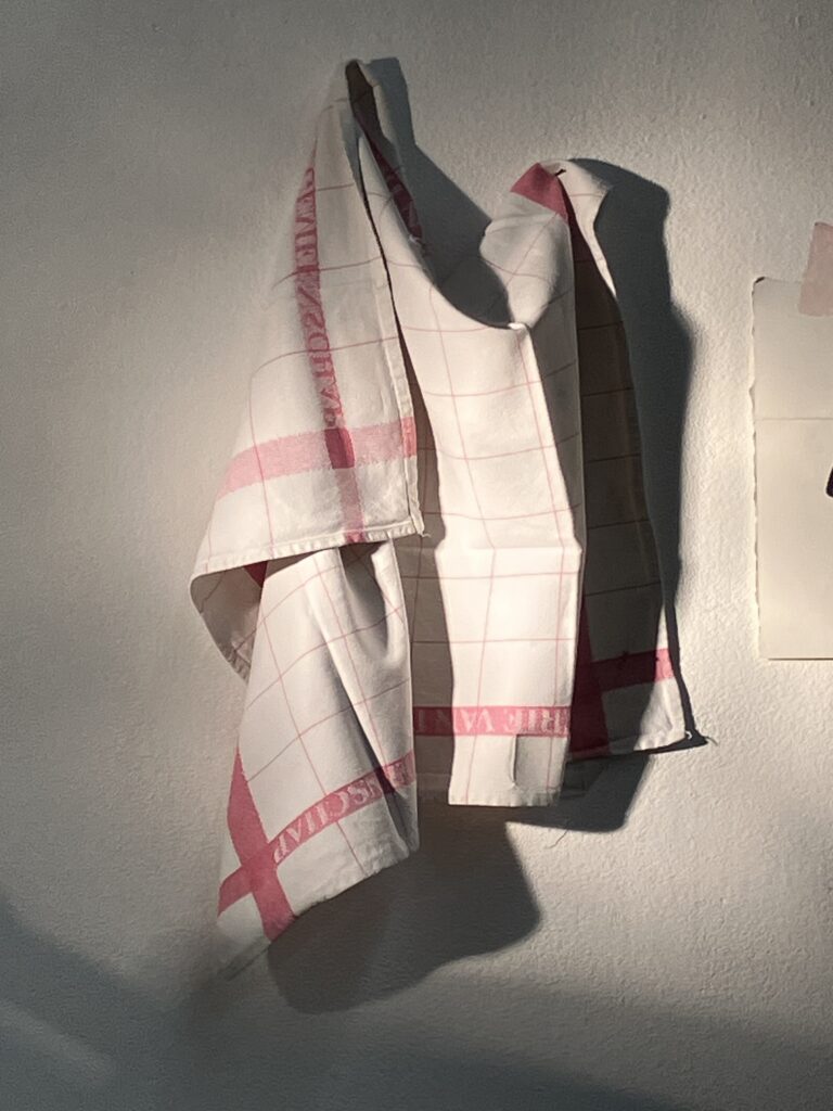 Photo of a starched towel pinned on the wall, with sharp contrasting shadows